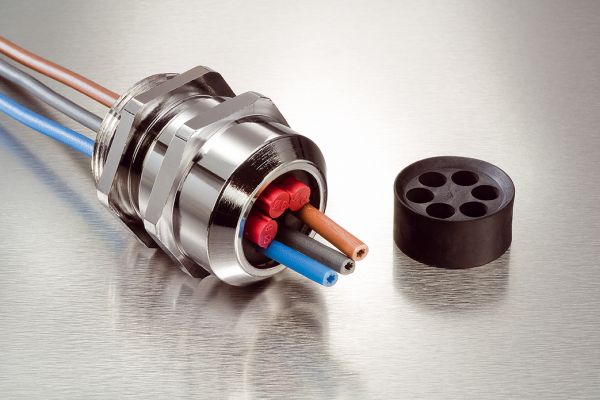 Stainless-steel cable gland with various black, red and yellow cables
